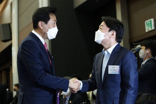 4.7 서울시장 보궐선거 야권단일화 맞수인 오세훈 국민의힘 후보(왼쪽)와 안철수 국민의당  후보가 지난 8일 오후 서울 영등포구 공군호텔에서 열린 제113주년 3·8 세계 여성의 날 기념식에서 악수하고 있다.[사진=연합뉴스]